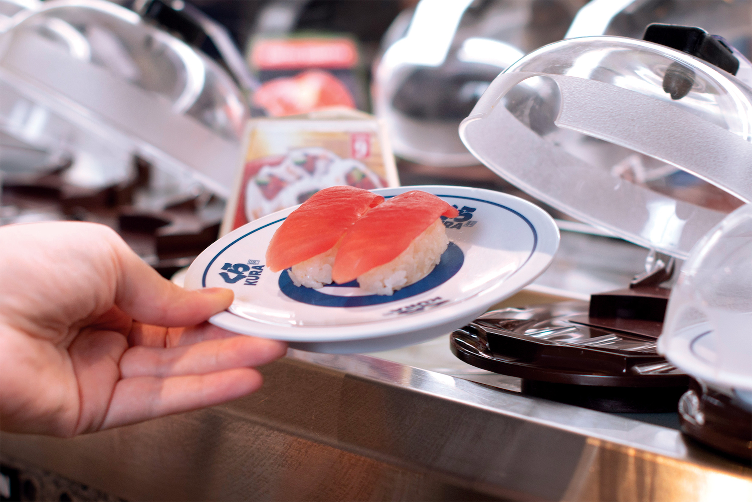 Revolving Sushi Restaurant With Robot Servers Kura Sushi Opening In   Photo By Emily J. Davis For Kura Sushi  Hand Grabbing Tuna Nigiri2 